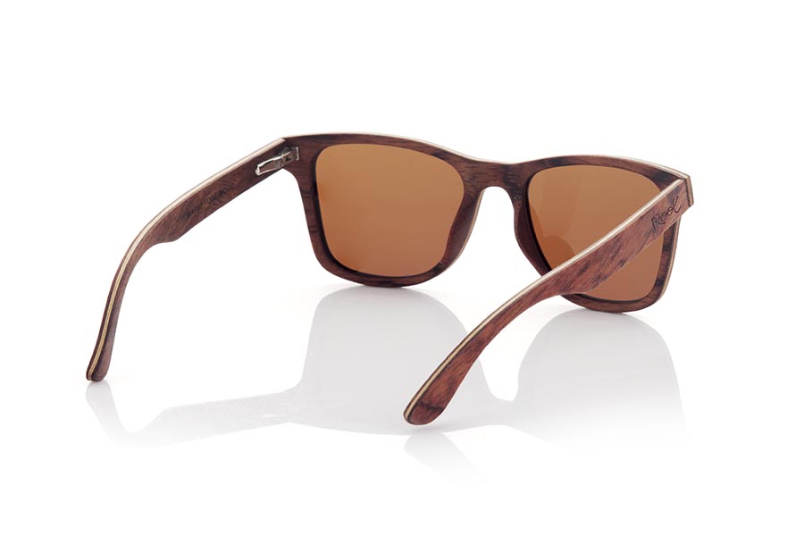 Wood eyewear of Rosewood MARIO. MARIO wooden sunglasses are a classic and timeless model that will perfectly complement any masculine look. Made entirely of laminated rosewood with a thin layer of maple interspersed, the combination of dark and light tones creates an elegant and subtle contrast. Fitting comfortably against the head, the temples are made from the same laminated wood for added durability. Classic styling and high-quality craftsmanship make these sunglasses a sophisticated and fashionable choice. Lenses available in solid shades of gray and brown provide full protection from the sun's rays. Front Measurement: 145x48mm Caliber: 52 for Wholesale & Retail | Root Sunglasses® 